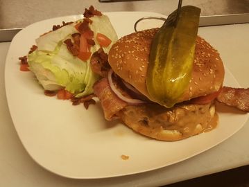 peanut butter Bacon Cheese Burger and a wedge salad on a plate