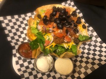 Taco salad with salsa and sour cream on a plate