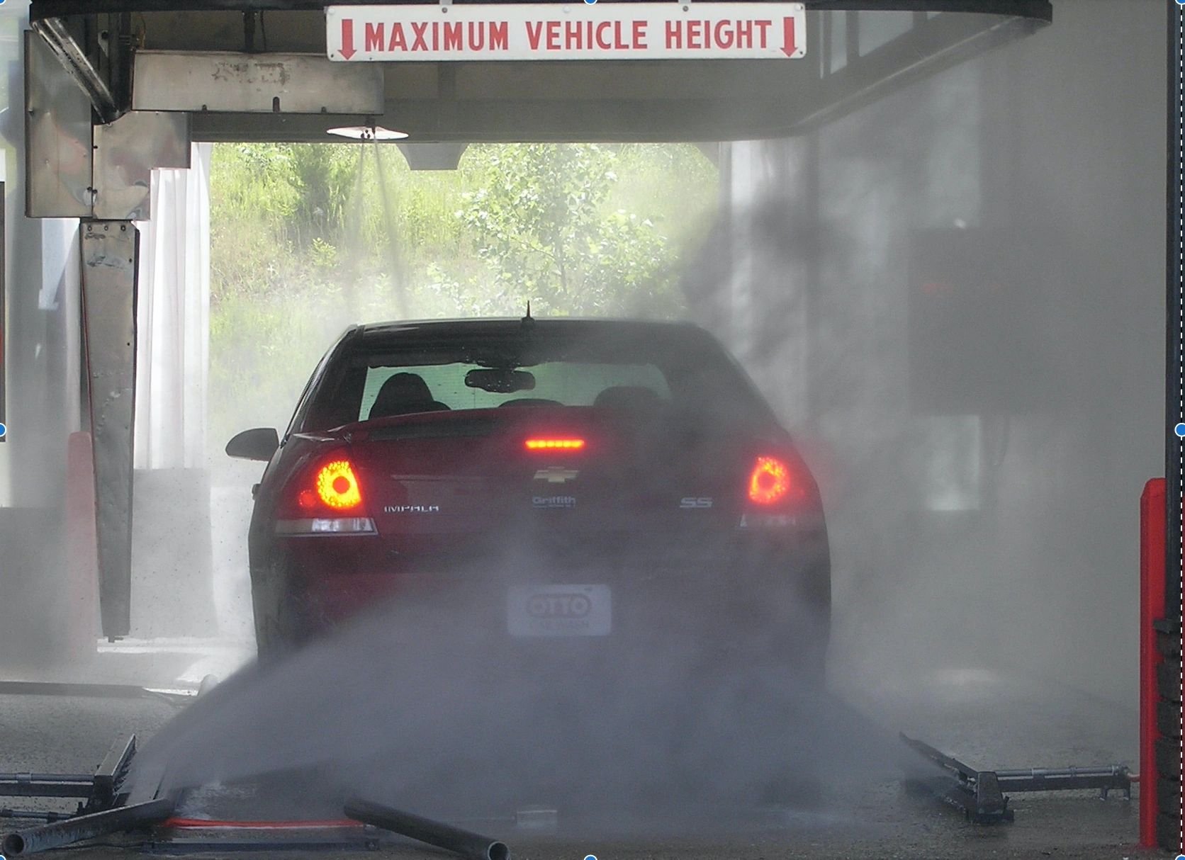 Automobile entering touches automatic car wash.