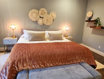 Cozy bedroom with a large bed and textured wall decor.