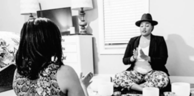 Black and white image of LaToya with a client during an in-person, 1:1 Alignment Session.