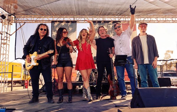 Band posing on stage after performance.