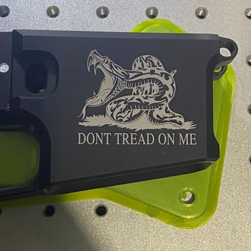 Custom laser engraving on an AR lower, Gadsden snake “Don’t tread on me”. 