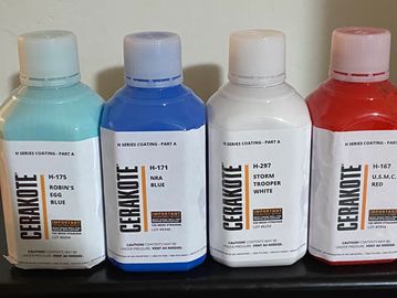 Four bottles of cerakote getting ready for use on a custom cerakote designed rifle