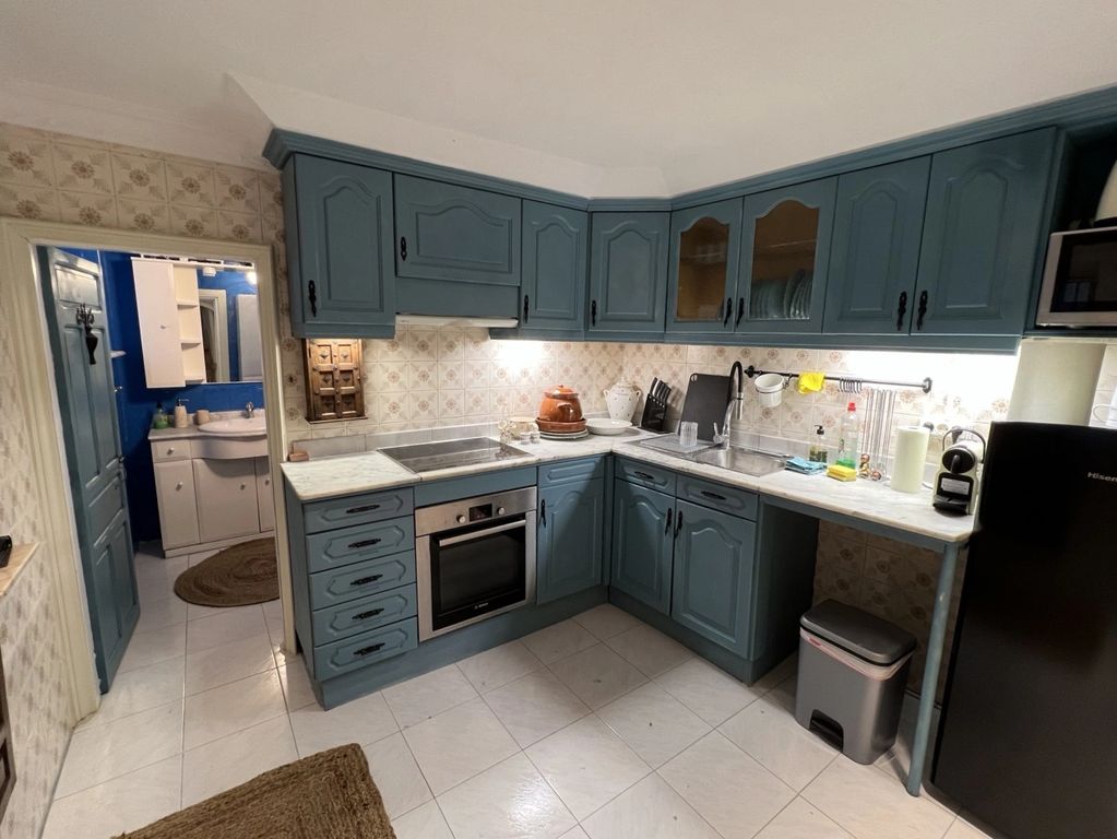 The kitchen and adjacent bathroom on the ground floor of Aldeon Luxury Suites