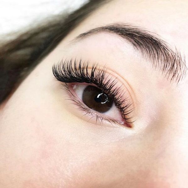 Close-up of an eye with long eyelashes.