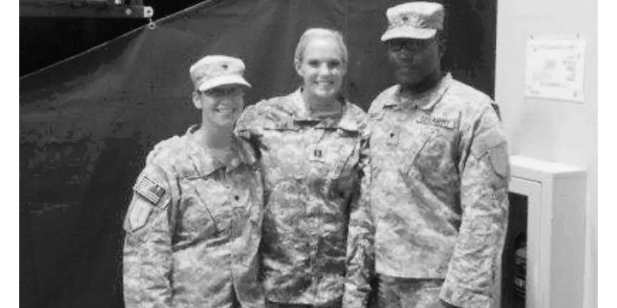 Three soldiers in uniform at their redeployment ceremony 