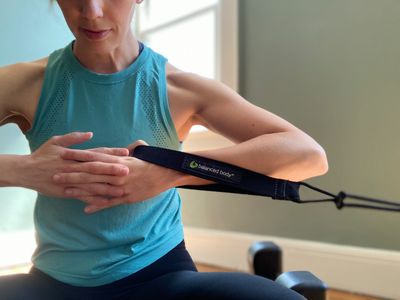 Woman exercising with a resistance band at home.