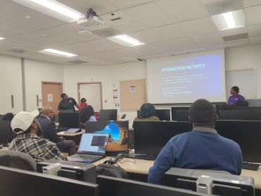 People attending an interactive presentation in a computer lab.