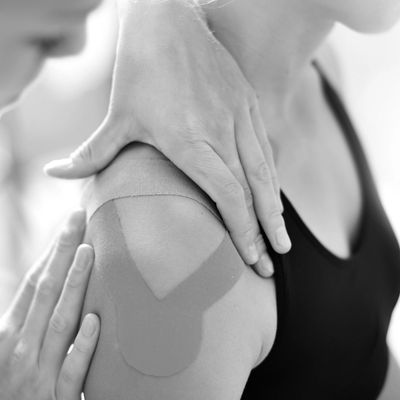 a lady with kinesiology tape on her shoulder