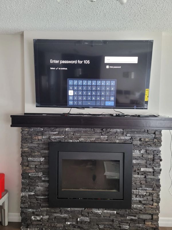 65" Sony bravia TV on top of a fireplace