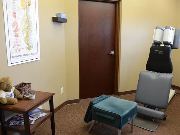 Chiropractic adjustment room with specialized equipment and calming decor.