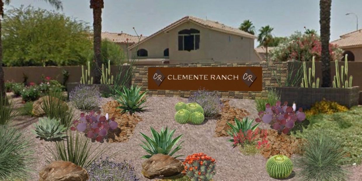 Welcome sign for Clemente Ranch surrounded by desert landscaping and cacti.