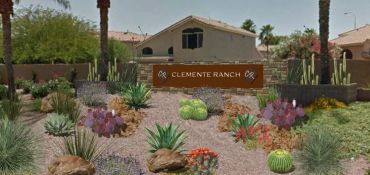 Desert-themed garden with various cacti and succulents at Clemente Ranch entrance.