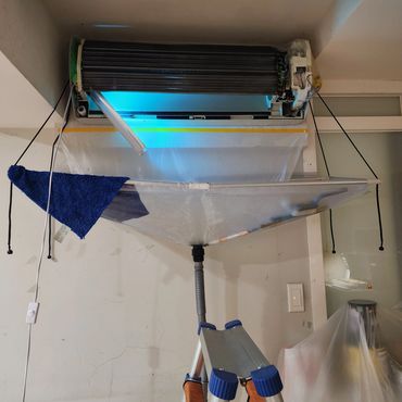 A ping pong table folded vertically in a room.