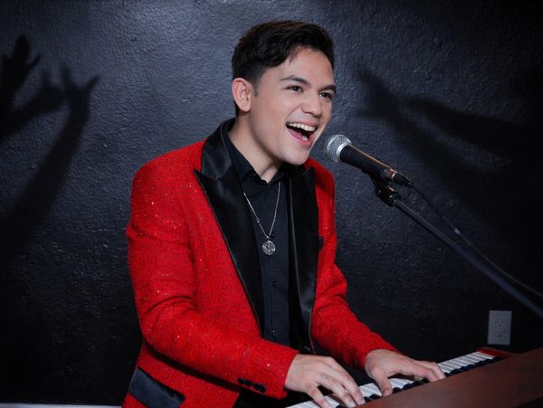 Live music at Melao Events, Kissimmee by School of Talent pianist-singer on stage (Alejandro Chin). 