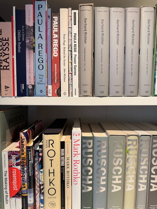 Bookshelf with art books featuring Paul Rego, Gerhard Richter, Mark Rothko, and Rusch