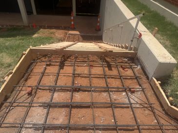 Rebar framework laid for a concrete stair ramp.