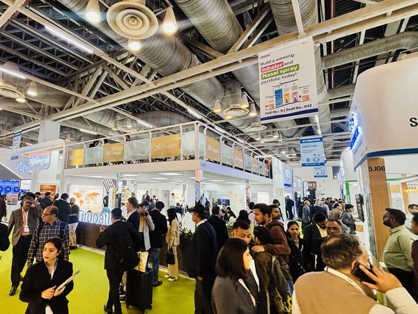 Busy trade show with many attendees and exhibition booths.