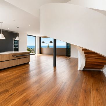 Spacious modern interior with wooden floors and a curved staircase.