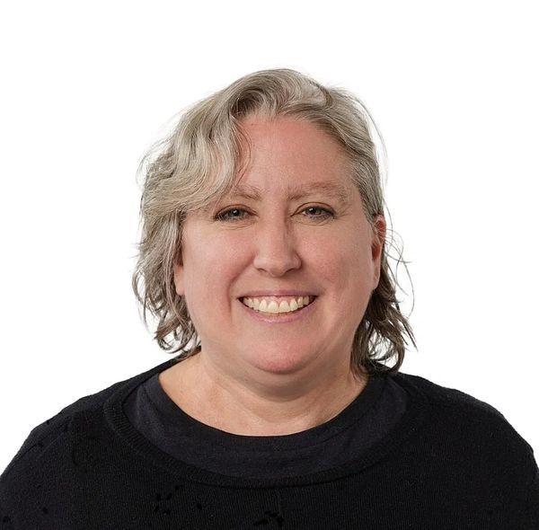 Smiling middle-aged woman with short gray hair.