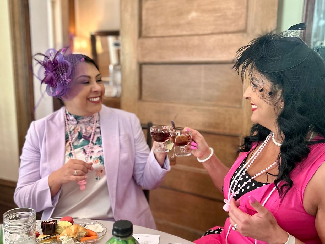 Ladies clinking teacups at Lambermont Events Tea Party for Baby Shower hosted at Lambermont Estate.