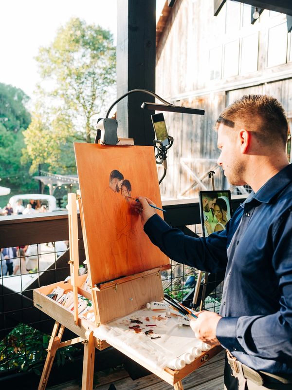 Live wedding painter in the process of painting live at a wedding in Ohio.