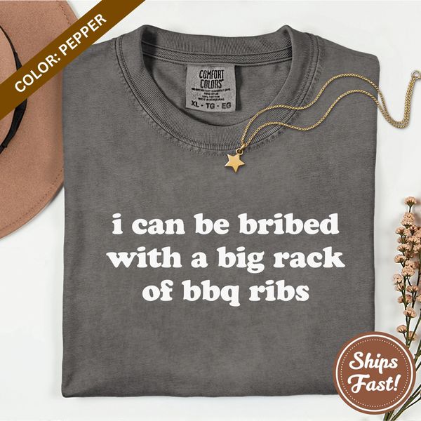Tee-Brain Gifts "Bribed With BBQ Ribs" t-shirt, folded. Shirt color is Pepper.