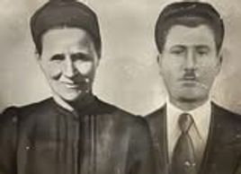 Black and white photo of a man and woman in formal attire.