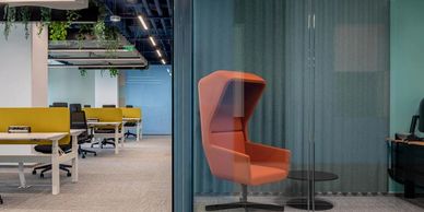 Boutique style working space with yellow, orange and blue colours, biophilia and acoustic solutions