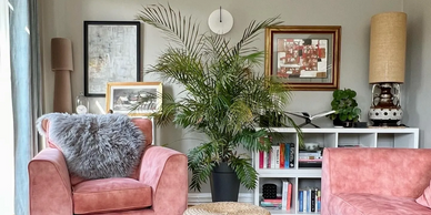 Town House reception room with salmon velvet upholstery sitting and layers of art pieces and rugs. 