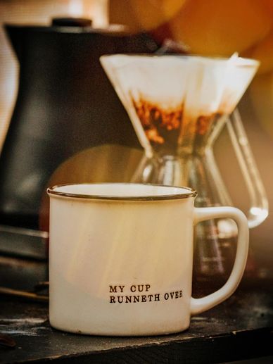 Cup with writing of "My cup runneth over" for donations