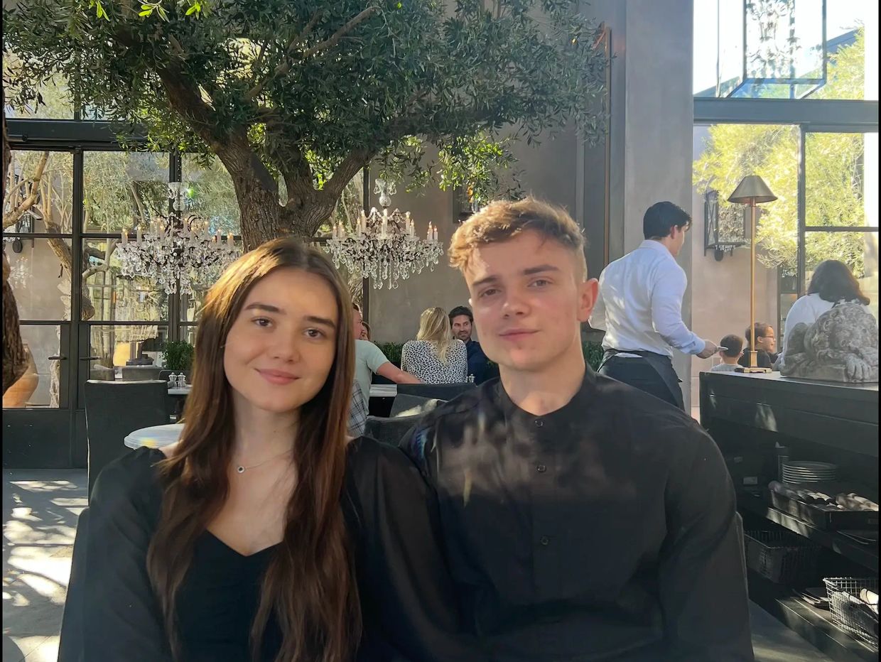 Image of 2 people wearing black at a restaurant, One person is the owner of DZAR Bookkeeping. 