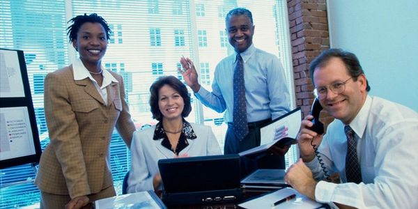 four people are in the office together 