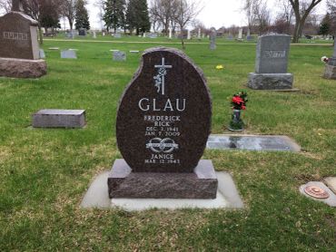 Gravestone with names Frederick and Janice Glau in a cemetery.