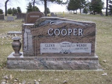 Gravestone for Glenn and Wendy Cooper in a cemetery.