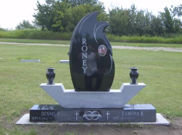 Modern black and white tombstone with urns.