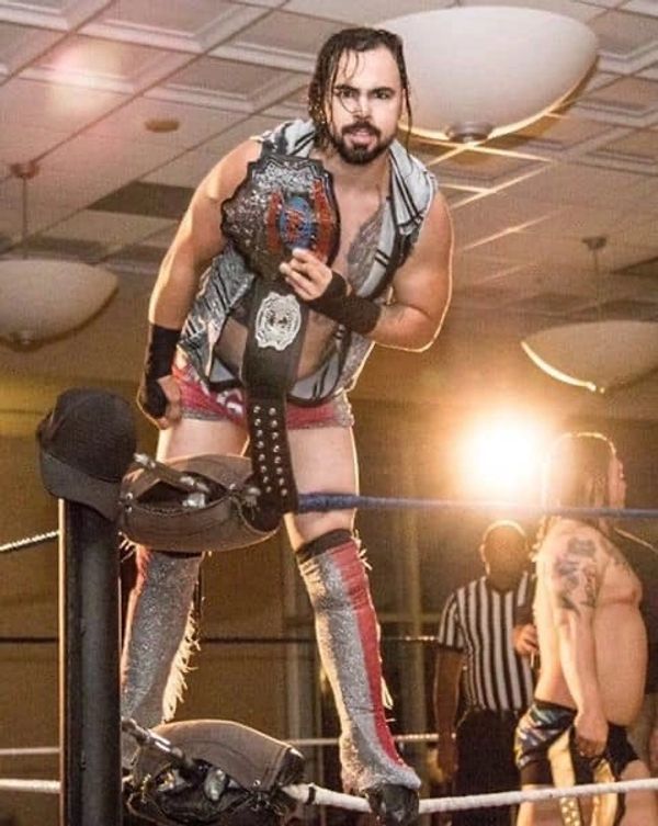 IPW Wrestler and Champion Sparrow showing off his belt and custom wrestling gear by Anastazia's