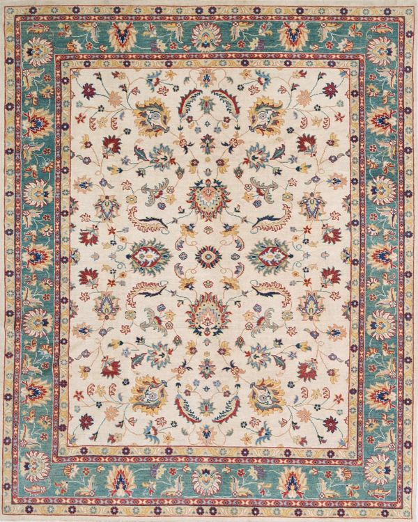 Elegant floral patterned rug with teal border and intricate designs.