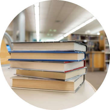 A stack of five books on a table.