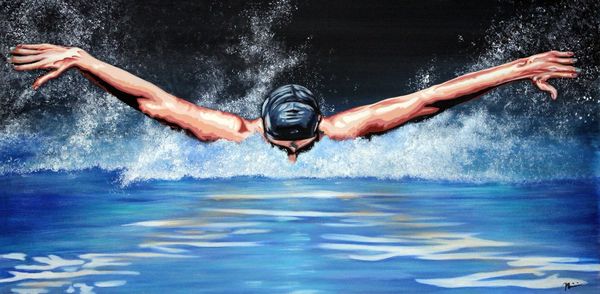 A swimmer performing a butterfly stroke in the water.