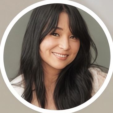 Portrait of a smiling woman with long dark hair.