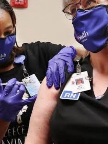 Nurse receiving a vaccination shot.