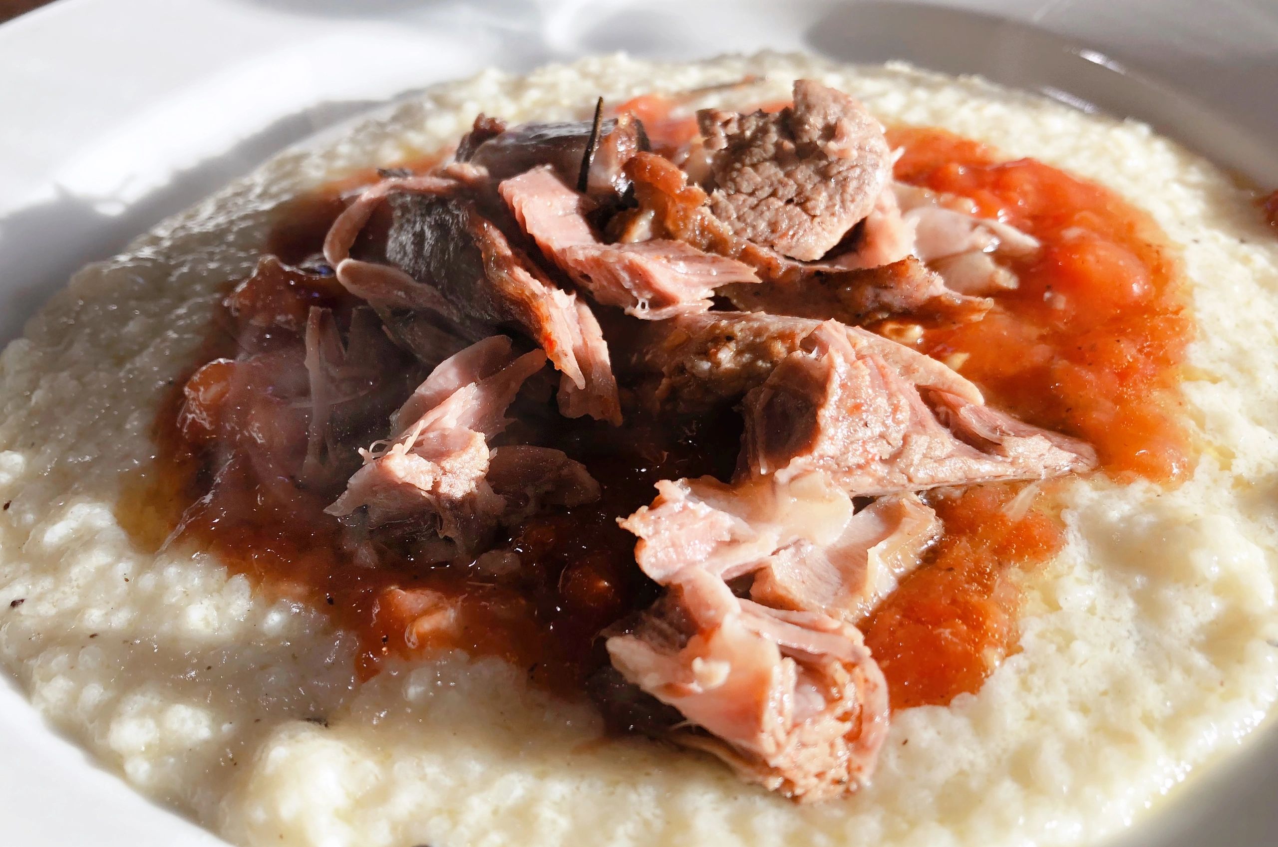 Braised Lamb shoulder Chops over goat cheese grits