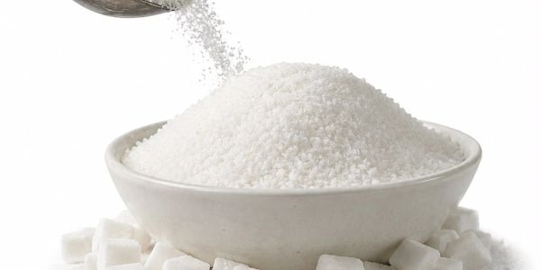 A bowl filled with granulated white sugar surrounded by sugar cubes.