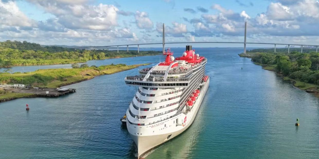 Brilliant Lady from Virgin Voyages passing under the iconic Centennial Bridge at the Panama Canal.