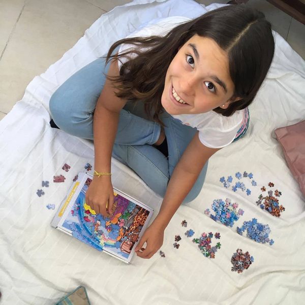 Girl completing Noah's Ark jigsaw puzzle