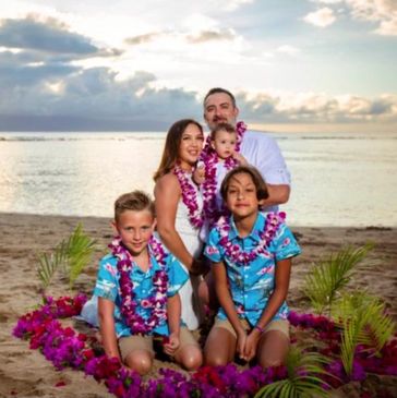 Family on Maui beach for renewal wedding ceremony, flower leis