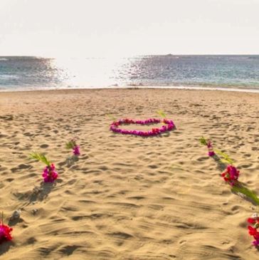 Flower heart and decoration on Maui beach for sunset wedding ceremony