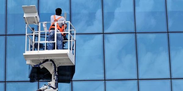Window cleaner working on a glass facades